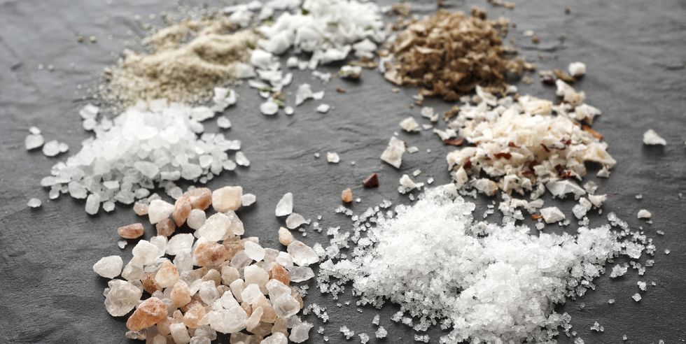 different types of salt crystals, sea salt, himalaya coarse salt, fleur de sel, chipotle flingsalt, hickory smoked salt, stone salt and garlic salt