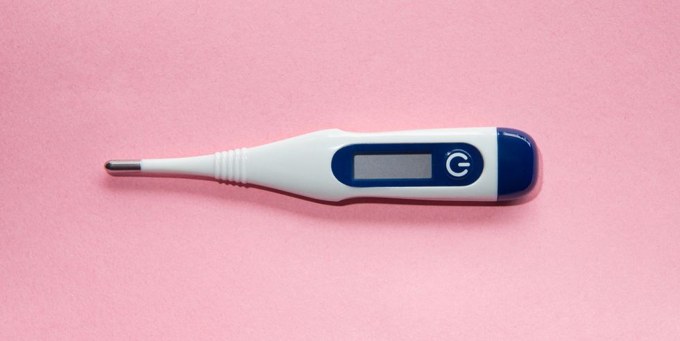 digital thermometer on pink background conceptual image for fertility, women's health and wellness