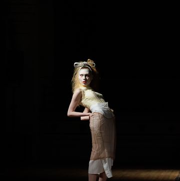 a person wearing a crown and standing on a stage