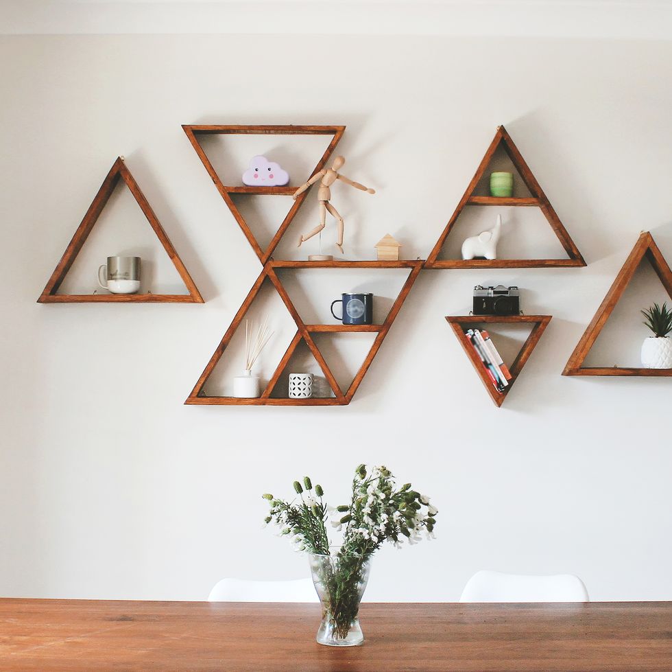 dining room area with triangle shelves as wall decor