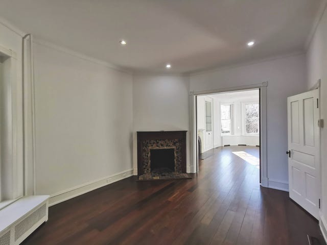 living room featuring a fireplace and an entry to another room