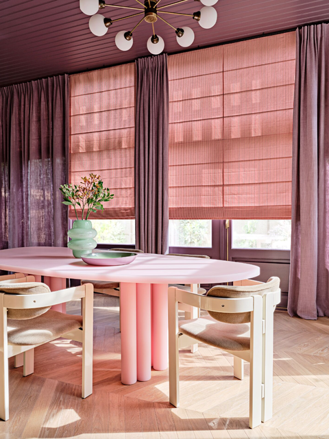 dining room with bubblegum pink dining table and neutral tan chairs
