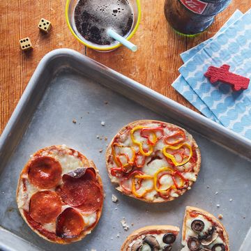 bagel pizzas on a tray with a variety of toppings