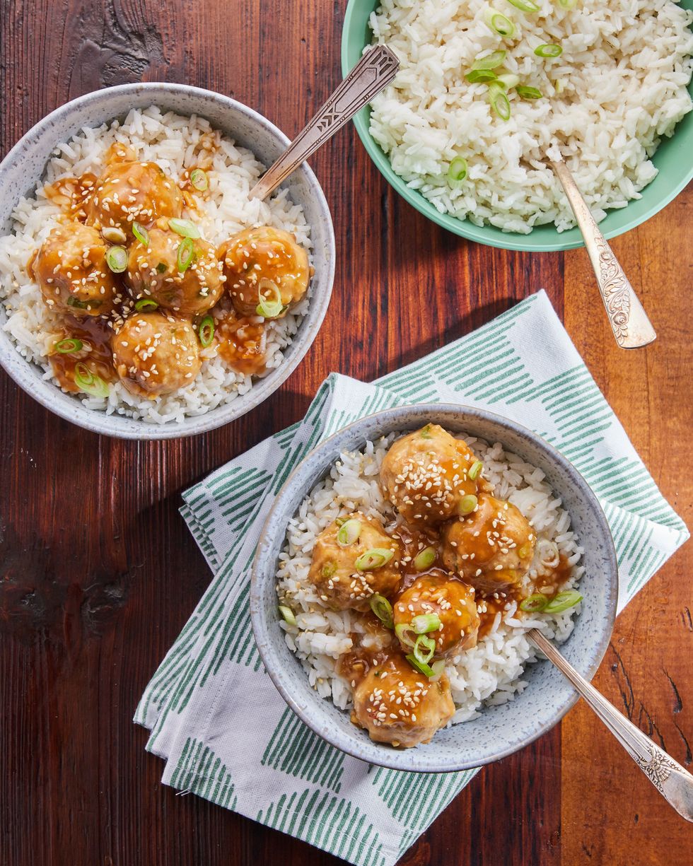 two servings of sesame chicken meatballs over rice