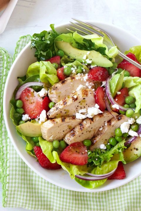 grilled chicken and strawberry cobb salad in a white bowl on a green gingham napkin
