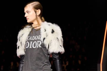 Fashion model showcasing winter attire with a graphic tshirt and faux fur outerwear