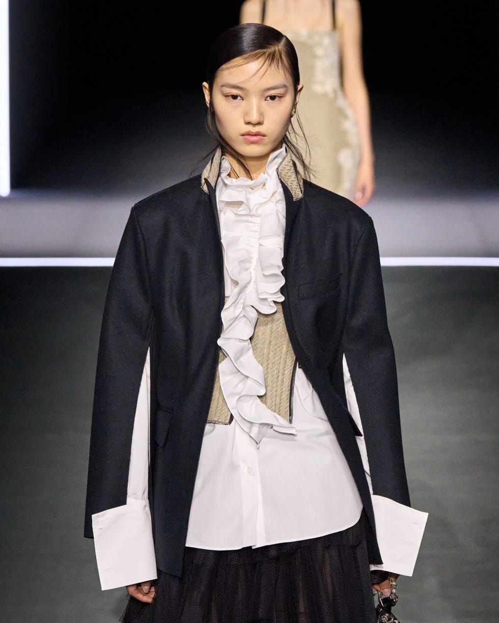 fashion model wearing a layered outfit featuring ruffles and a blazer