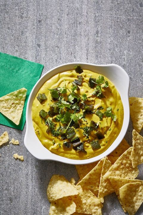 queso dip with cilantro and green peppers on top