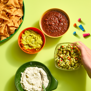 Assortment of dips in bowls including salsa, guacamole and tzatziki assortment of dips in bowls including salsa, guacamole and tzatziki