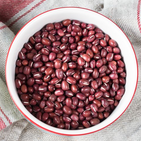 directly above shot of adzuki beans in bowl on napkin