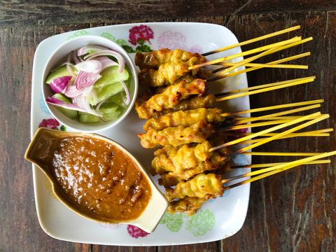 Chicken Satay And Salad With Sauce In Plate On Table