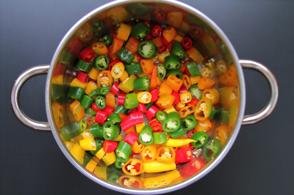 directly above shot of chili peppers in stainless steel bowl