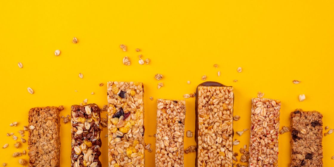 variety of granola bars on a yellow background