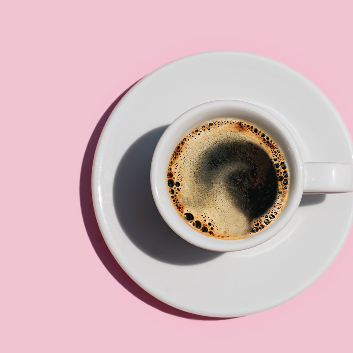 directly above shot of coffee on pink color background.