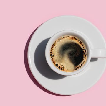 directly above shot of coffee on pink color background.