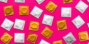 directly above shot of condom packets over pink background