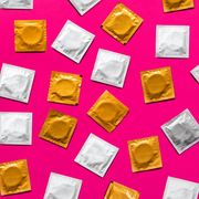 directly above shot of condom packets over pink background