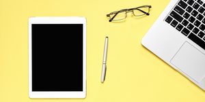Directly Above Shot Of Digital Tablet With Pen And Laptop On Yellow Background