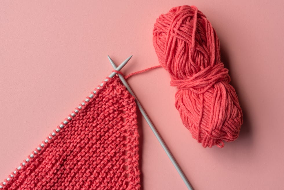 directly above shot of knitting needle with crochet on colored background
