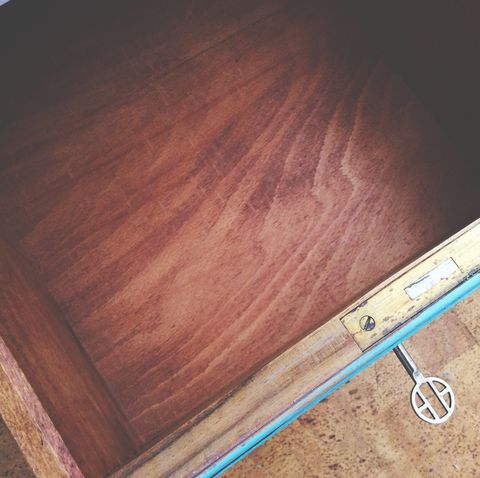 directly above shot of open drawer with key