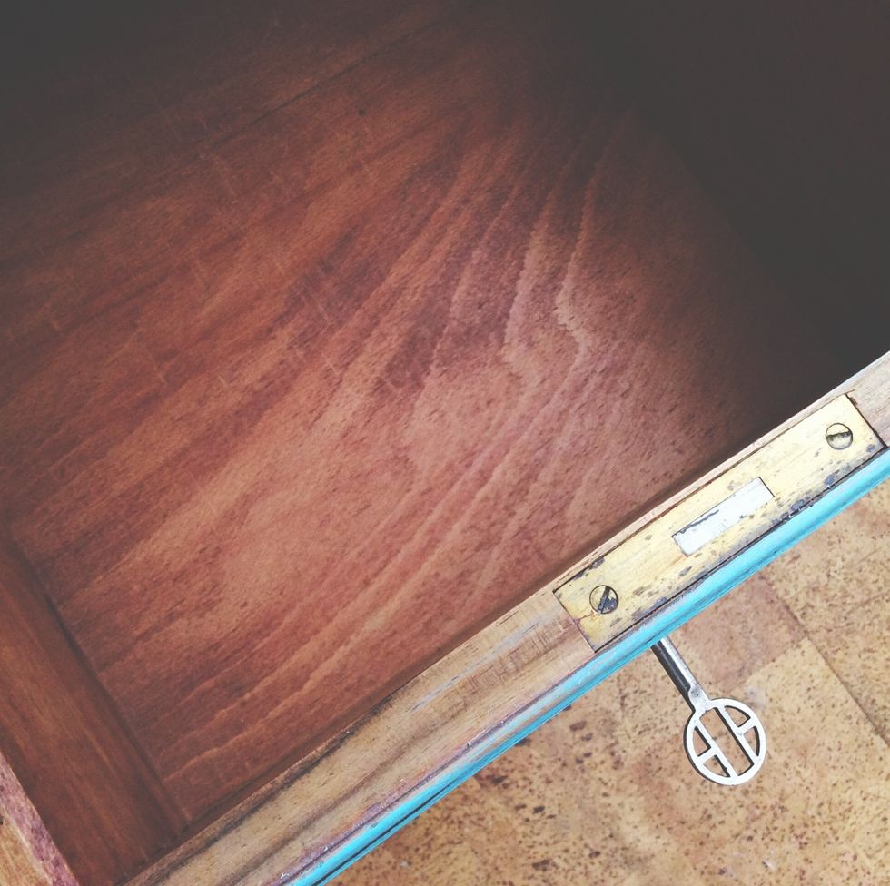 directly above shot of open drawer with key