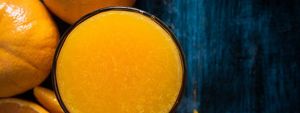 Directly Above Shot Of Oranges By Juice In Glass On Table