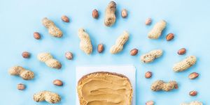 directly above shot of peanut butter on bread against blue background