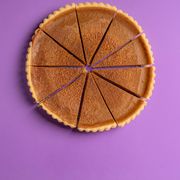 directly above shot of pumpkin pie on purple background