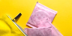Directly Above Shot Of Sanitary Pads With Purse On Yellow Background