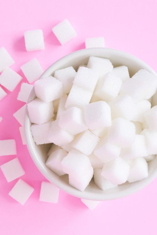 Directly Above Shot Of Sugar Cubes In Bowl Against Pink Background