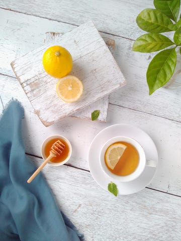 Directly Above Shot Of Tea By Lemons On Table