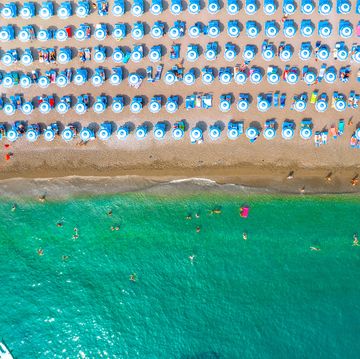 directly above view of large group of tidy beach umbrellas in the south of italy