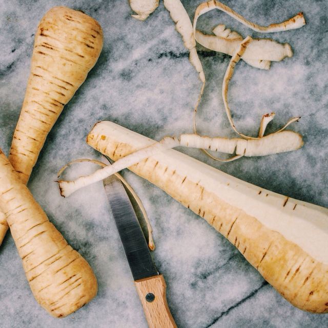directly above view of parsnips with knife on table
