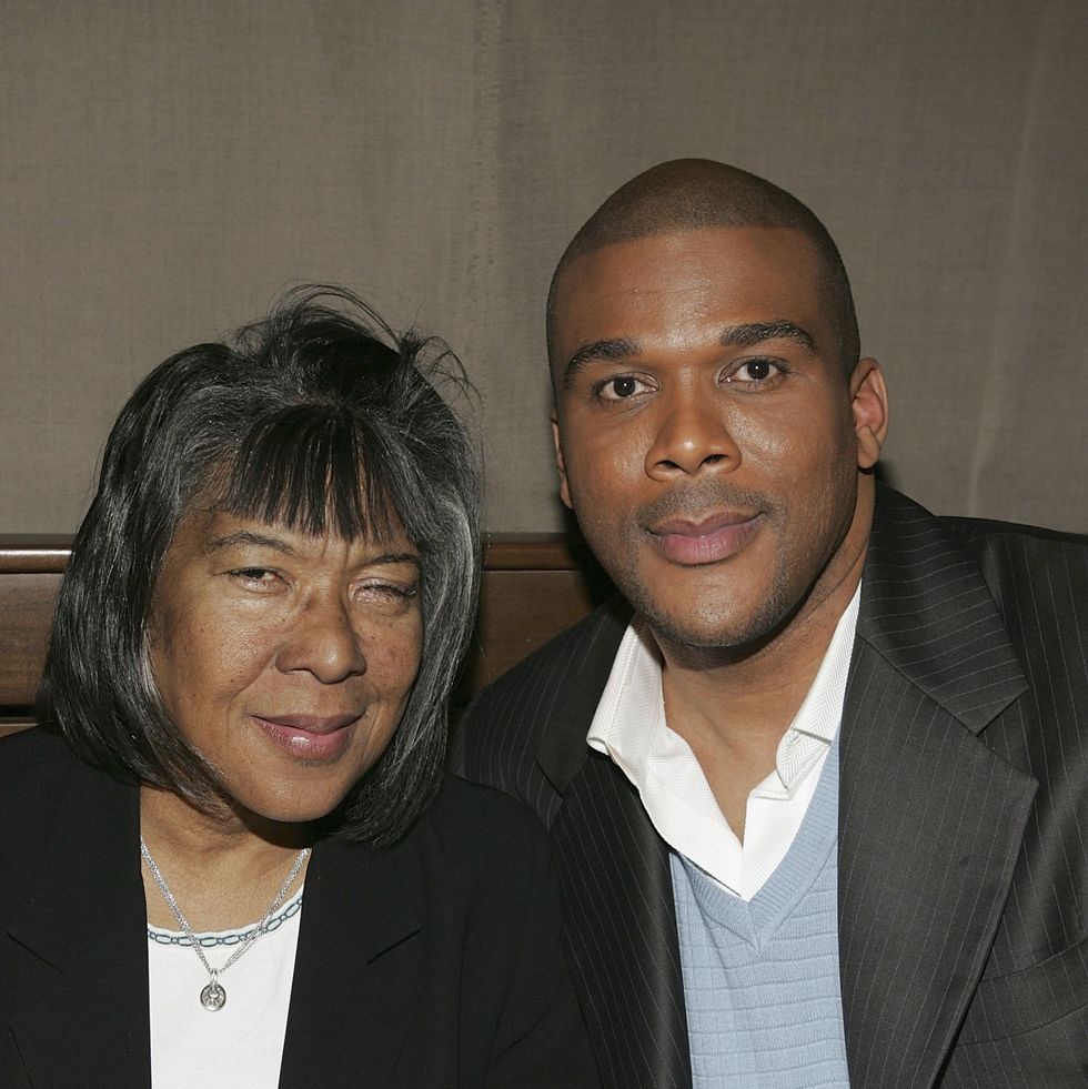 a woman and a man sit close together and look at the camera for a photo