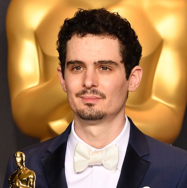 director and screenwriter damien chazelle holding up his oscar at the 89th annual academy awards