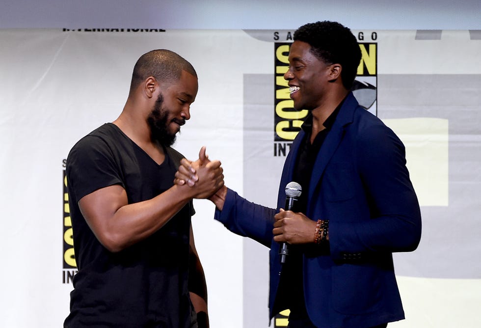 ryan coogler and chadwick boseman greet each other with a friendly handshake