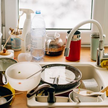 dirty dishes piling up in kitchen sink after meal