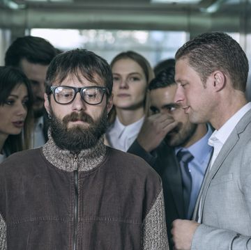 a dirty hipster affecting his coworkers in an elevator