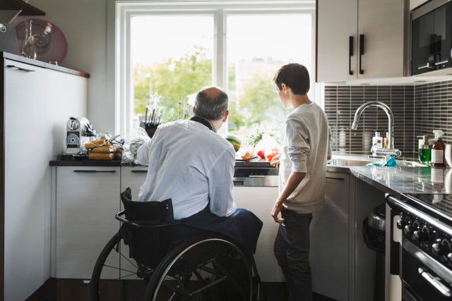 https://hips.hearstapps.com/hmg-prod/images/disabled-father-preparing-food-son-in-kitchen-royalty-free-image-1614119727.?crop=0.668xw:1.00xh;0.235xw,0&resize=640:*