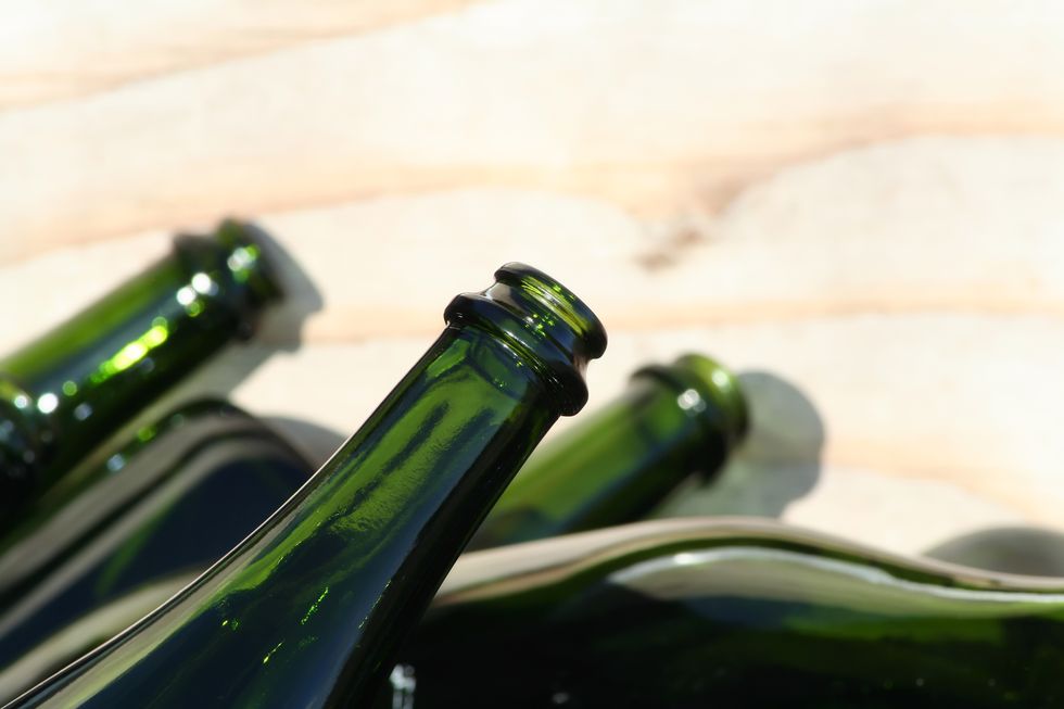 discarded green wine bottles