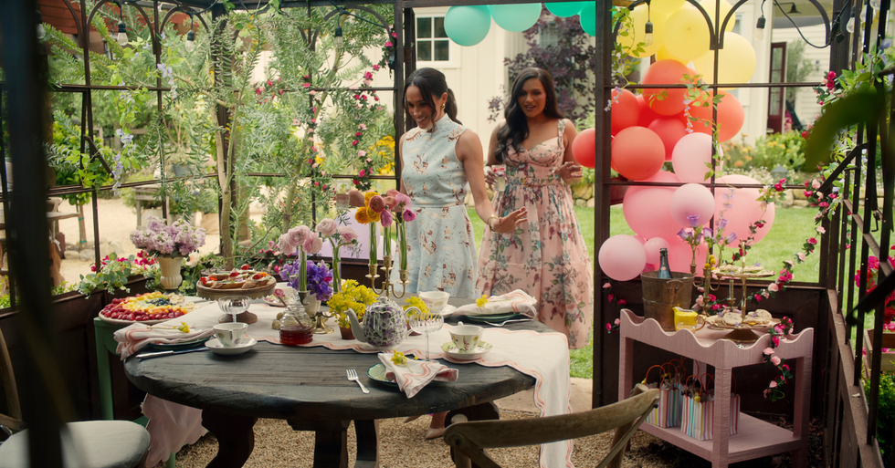 a gathering featuring a beautifully arranged outdoor table with food and decorations