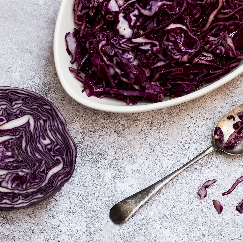 a dish of cooked red cabbage and half a raw cabbage