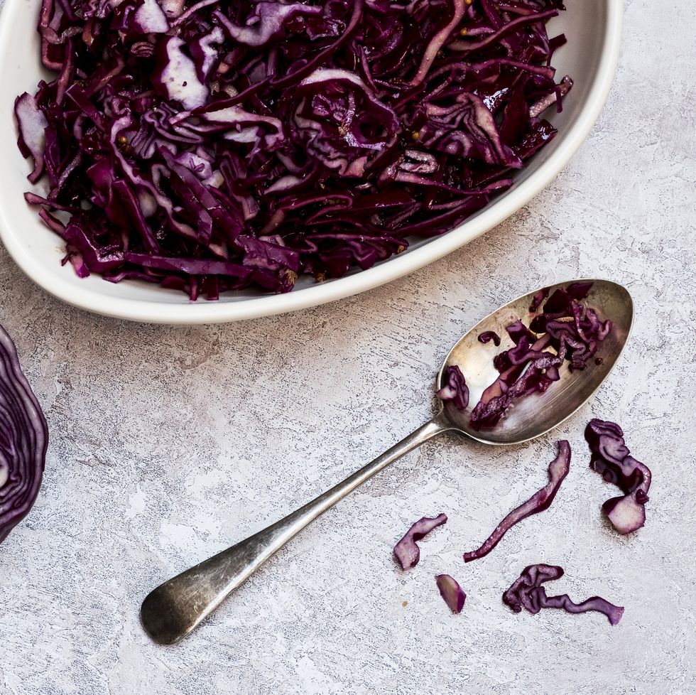 a dish of cooked red cabbage and half a raw cabbage