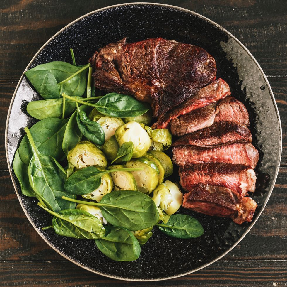 steak, brussels sprouts and spinach top view for good housekeeping's alpha lipoic acid benefits story
