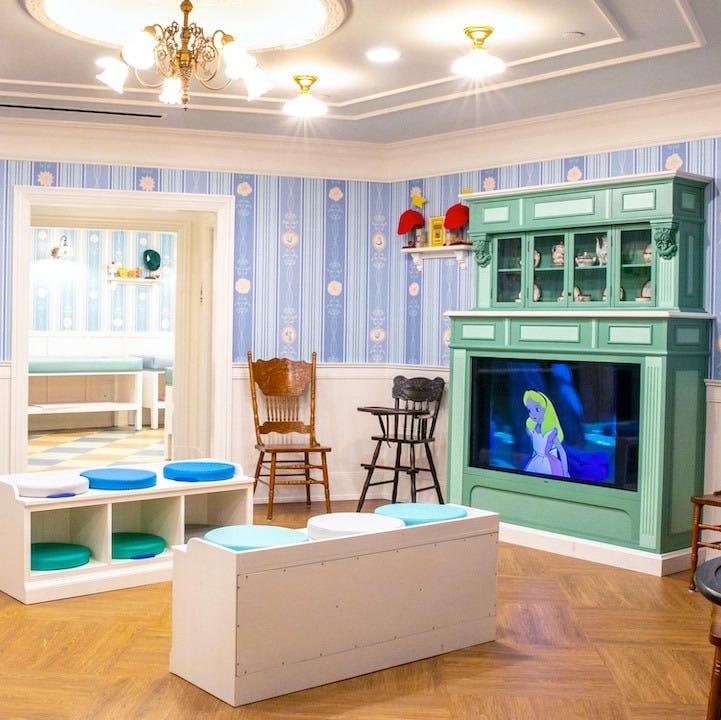 disney baby care center a room with a tv and chairs