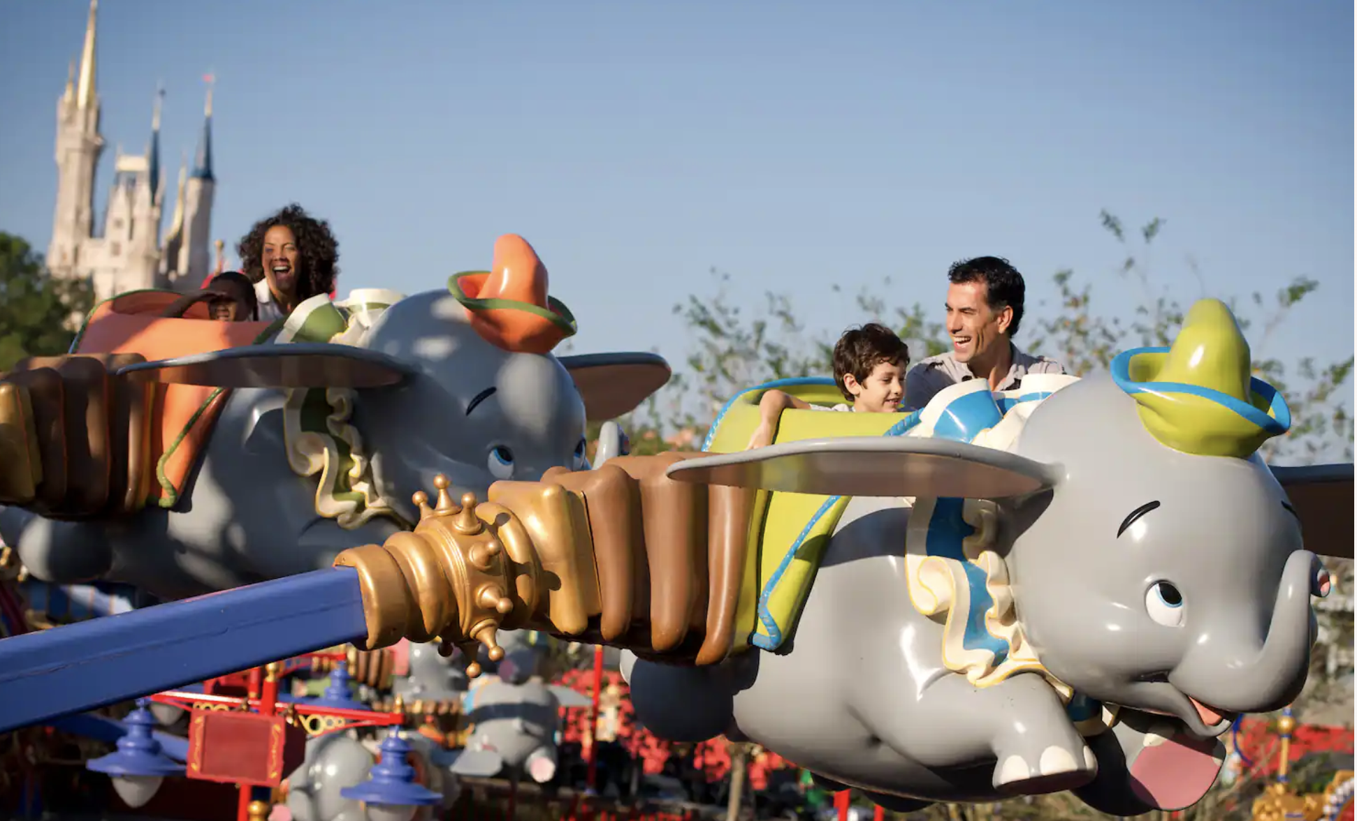 passengers riding dumbo the flying elephant at walt disney world's magic kingdom park