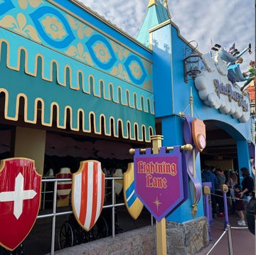disney lightning lane review - lightning lane booking strategy two entrances to amusement park rides showcasing different designs and queue lines