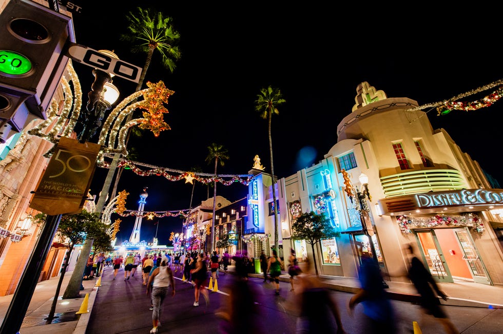 runners make their way through disney world during the disney wine and dine half marathon