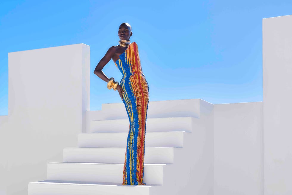 a person in a colorful dress standing on a staircase