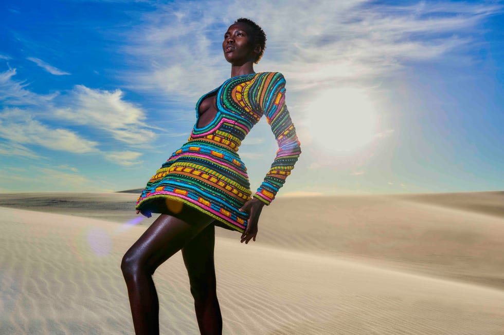 a person in a colorful dress on a sandy beach